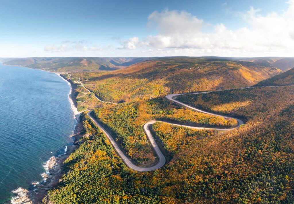 Cabot Trail winding along Cape Breton coastline with ocean views in Nova Scotia